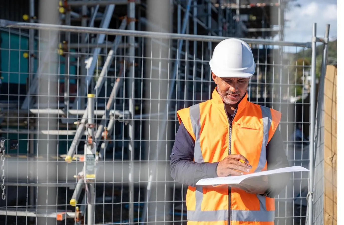 Structural engineer reviewing plans on site